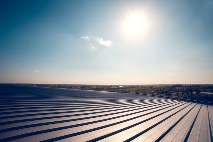 Metal panel building roof construction