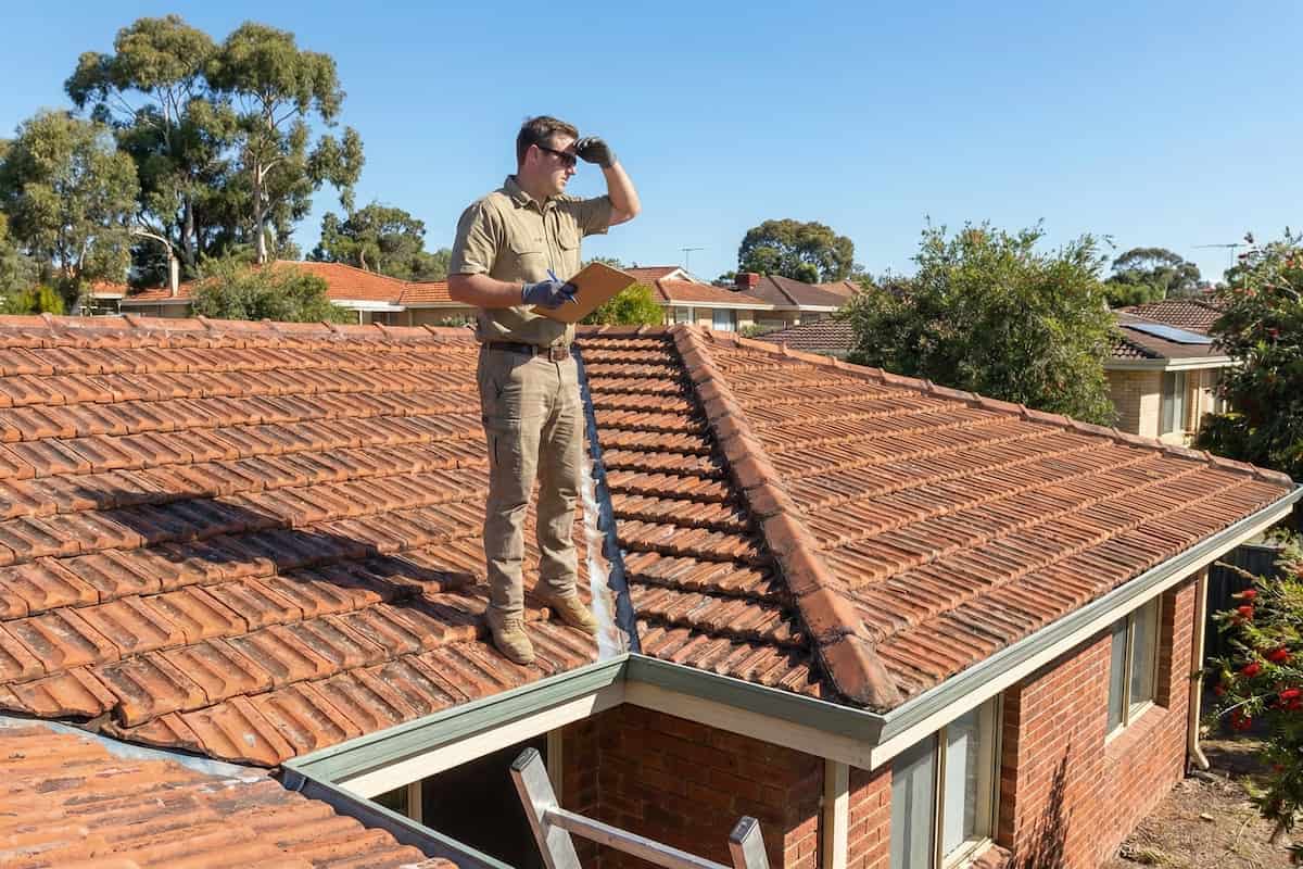 free-roof-audit Free roof audit being carried out on a Perth suburban home during gutter cleaning.