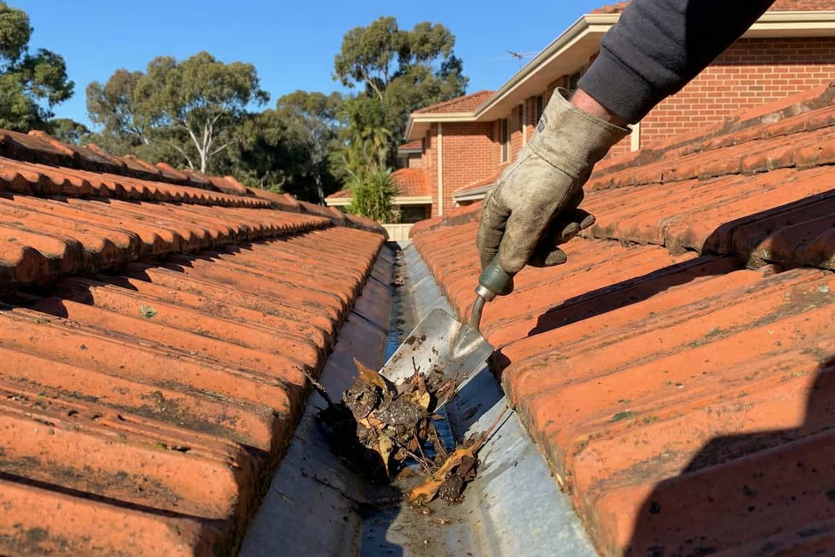 Roof valley clearing with leaves and debris being removed on a Perth suburban home.